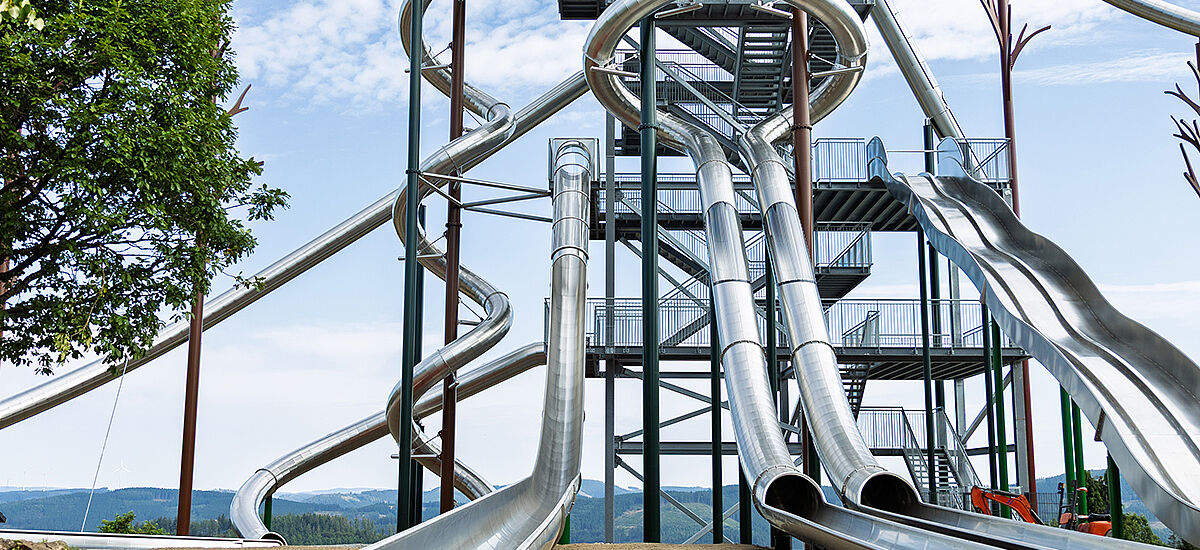 Slide tower at Panorama Park Sauerland with red REGUPOL playfix FX50 safety tiles at the slide exits