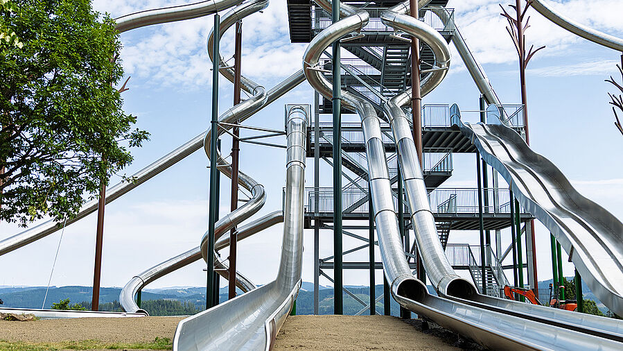 Slide tower at Panorama Park Sauerland with red REGUPOL playfix FX50 safety tiles at the slide exits